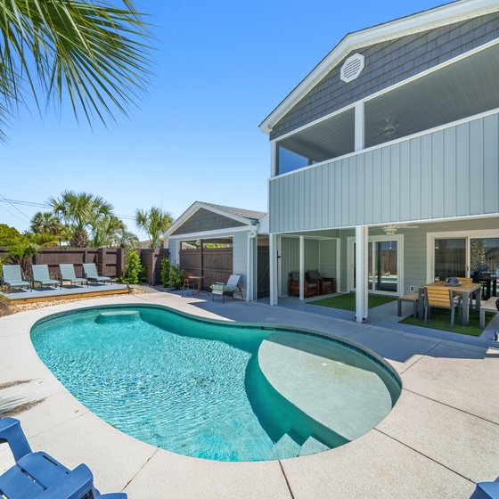 Modern coastal retreat with sparkling pool and tropical palms creating your perfect Florida getaway.