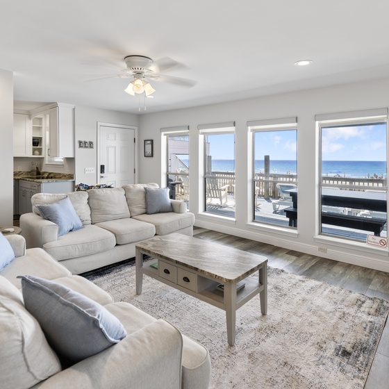 Unwind in your bright living space where panoramic ocean views frame every moment of your beachfront escape.
