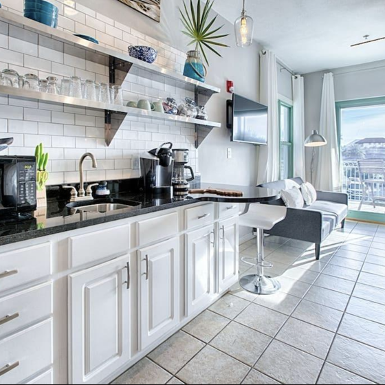 Your modern kitchen features granite counters, white subway tile, and city views for culinary adventures.