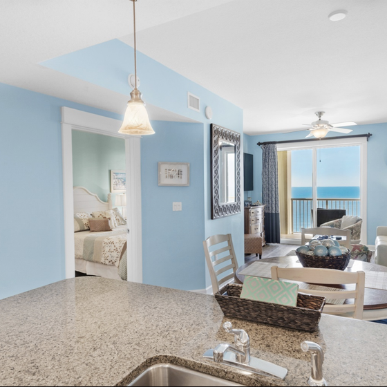 Your open kitchen flows into a bright living space where stunning ocean views through glass doors create the perfect coastal retreat.
