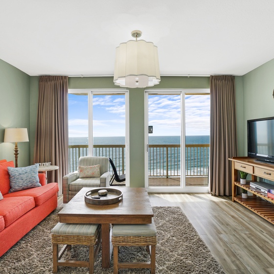 Relax in your bright oceanfront living room with panoramic sea views and comfortable coral sofa.