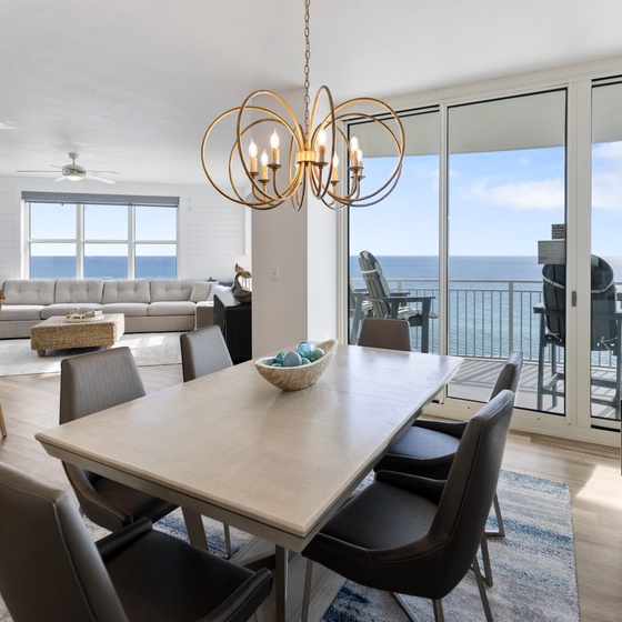Gather around your elegant dining table while soaking in breathtaking ocean views through floor-to-ceiling windows.