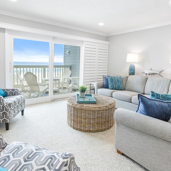 Sink into coastal comfort with plush seating and ocean breezes flowing through your bright living space.