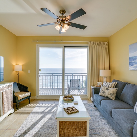 Unwind in your bright coastal living room with ocean views through sliding doors to your private balcony.