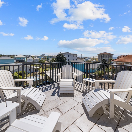 Relax in comfort on your private terrace with Adirondack chairs, perfect for morning coffee or evening conversations with neighborhood views.