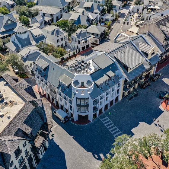 Aerial view showcases the distinctive property architecture and surrounding neighborhood's charming streetscape.