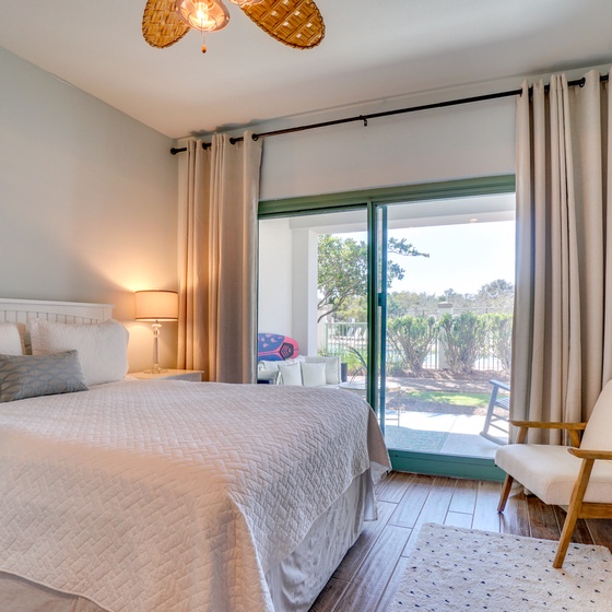 Drift into peaceful slumber in this bright bedroom with soft linens, natural textures, and lovely garden views just outside your door.