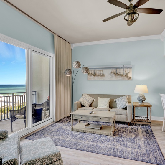 Your oceanfront living room features soothing coastal colors and stunning sea views through floor-to-ceiling windows.