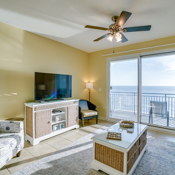 Unwind in your coastal living room where ocean breezes flow through, comfortable seating awaits, and stunning sea views create the perfect backdrop for relaxation.
