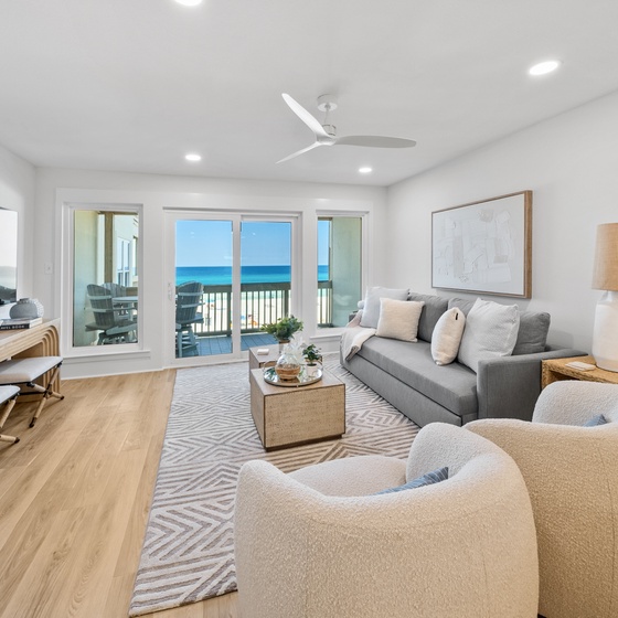 Unwind in your bright living room with stunning ocean views through floor-to-ceiling windows and a private balcony.