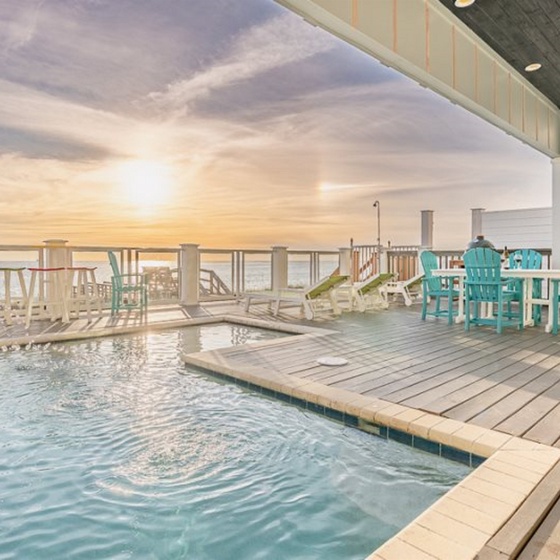 Your private pool deck awaits with turquoise waters and colorful seating, perfect for morning coffee or sunset cocktails.