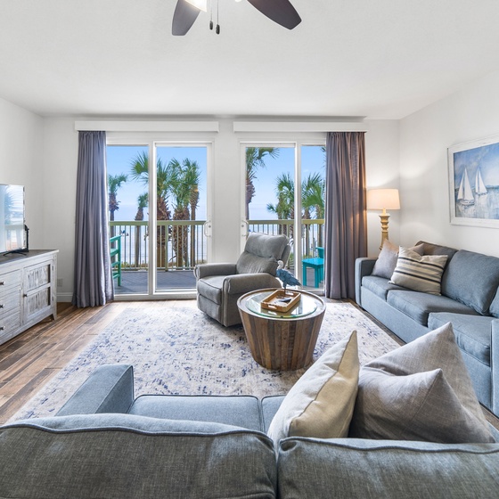 Sink into coastal comfort in your spacious living room, where ocean breezes flow through your private balcony.