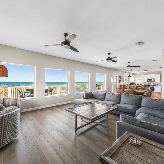 Sink into plush sofas while ocean breezes flow through your spacious living room with breathtaking sea views stretching to the horizon.
