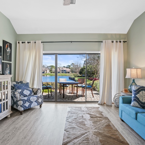 Unwind in your serene living space where lake views frame your perfect getaway. Cozy seating and thoughtful touches create your peaceful retreat.
