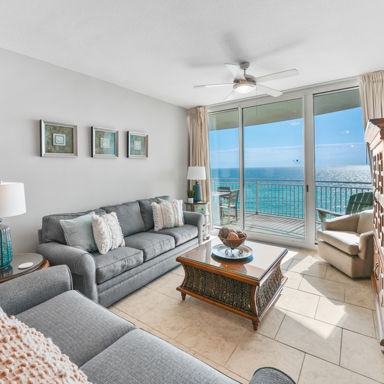 Relax in your bright living room with stunning ocean views through floor-to-ceiling windows and step out to your private balcony.
