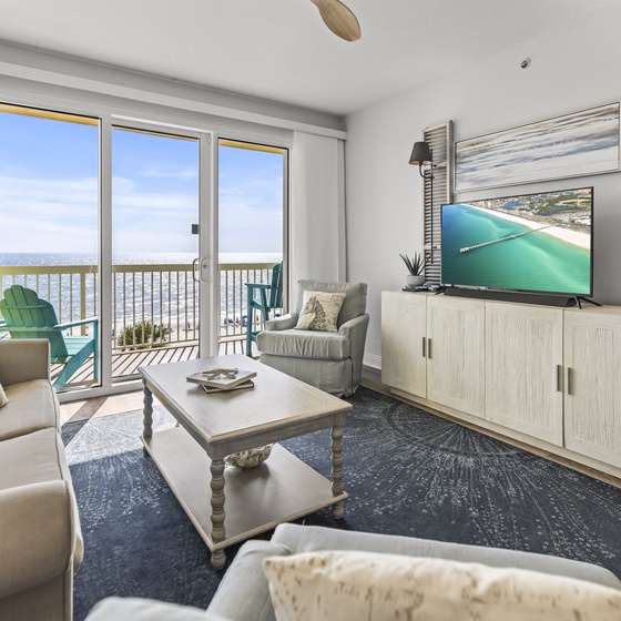 Relax in your coastal living room with stunning ocean views, comfortable seating, and a private balcony for morning coffee.