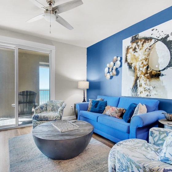 Unwind in your stylish living space where ocean blues meet modern comfort, complete with a ceiling fan and stunning sea views from your private balcony.