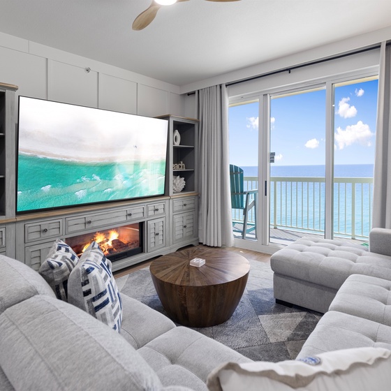 Sink into plush sofas while ocean waves fill your screen and real sea views frame your perfect coastal retreat.