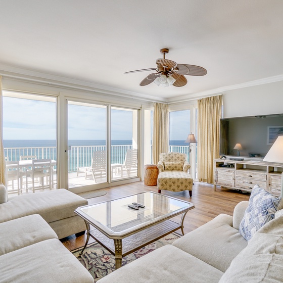 Relax in your spacious living room with breathtaking ocean views through floor-to-ceiling windows and direct balcony access.