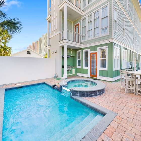 Step into your private paradise with sparkling pool, hot tub, and tropical palms creating the perfect outdoor retreat.