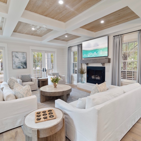 Unwind in your beautifully designed living space with vaulted wood-beam ceilings, plush seating, and a cozy fireplace perfect for relaxed evenings together.