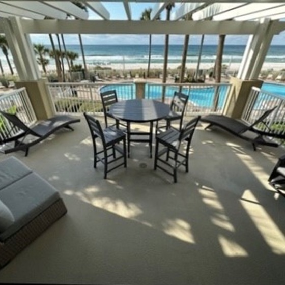 Relax on your private covered terrace with stunning ocean views, poolside comfort, and coastal breezes surrounding you.