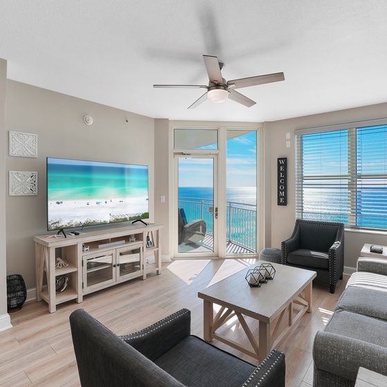 Relax in this spacious living room where ocean views stretch endlessly beyond your private balcony.