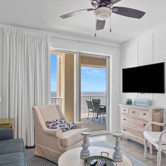 Relax in your bright coastal living room with ocean views from your private balcony and comfortable seating for unwinding.