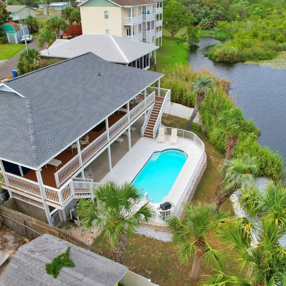 Stunning waterfront property featuring private pool and lake access in peaceful tropical setting.