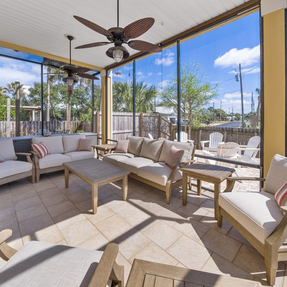 Relax in your screened patio with plush seating and tropical views. The ceiling fan keeps you cool while you enjoy the peaceful atmosphere.