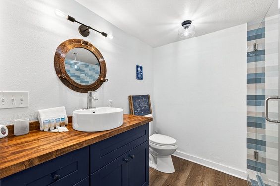 Refresh in your private bathroom with rustic charm and coastal flair. The vessel sink, wood vanity, and unique mirror blend style with comfort for your stay.