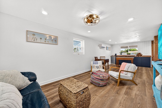 Bright, open living space with cozy seating and coastal touches—perfect for unwinding after a day of exploring. Natural light fills your inviting retreat.