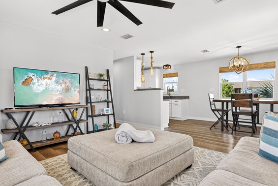 Sink into the plush seating, unwind beneath the ceiling fan, and let coastal vibes wash over you in this bright, open living space with modern amenities.