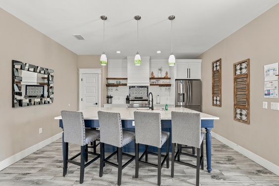 Gather around the spacious island for morning coffee or evening wine, with bar seating for four and a bright, modern kitchen at your fingertips. Warm tones and charming décor make this your perfect home base.