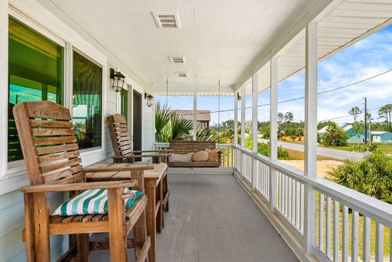 Settle into your rocking chair and watch the neighborhood come to life—cool breeze, warm sunshine, and peaceful moments waiting just for you on this charming covered porch.