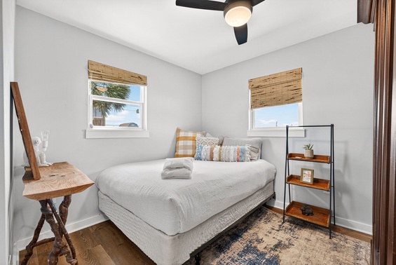 Your bedroom awaits with soft linens, coastal breezes through bamboo shades, and glimpses of swaying palms outside—designed for effortless relaxation after a day of exploring.