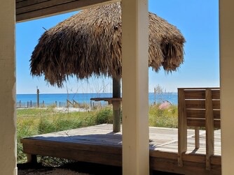 Your private beachfront retreat opens to sugar-white sand and turquoise waters, with natural palm-thatched umbrellas offering shade just steps away. Pure paradise awaits.