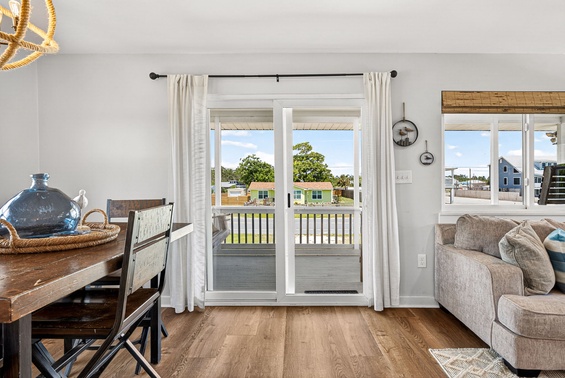 Sunlight pours through glass doors onto warm wood floors as you take in views of the surrounding neighborhood from your cozy living and dining area.