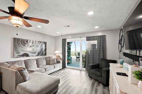 Sink into plush seating beneath the glow of recessed lighting, with pool views through sliding glass doors inviting you to step outside and unwind.