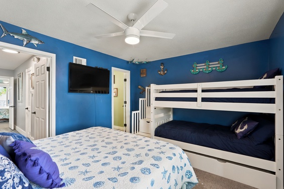 Dive into your seaside getaway in this nautical-themed bedroom where ocean blue walls and playful decor set the scene for coastal dreams. Your crew will love the spacious bunk beds and comfortable queen bed.