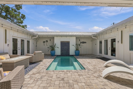 Step into your private courtyard oasis, where a sparkling pool awaits beneath sunny skies. Lounge on the chic seating, soak up the coastal breeze, and let every moment feel like pure vacation bliss.