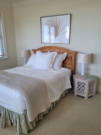 Slip into crisp white linens and unwind in your serene bedroom. Modern art and soft lighting create the perfect space for your restful retreat.
