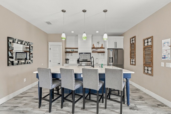 Gather around the spacious kitchen island for meals and conversation in this bright, open space with modern appliances and thoughtful details.
