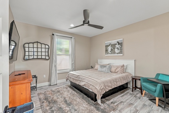 Your bright, airy bedroom features soft neutrals, a plush queen bed, and whimsical touches—perfect for peaceful mornings and restful nights.