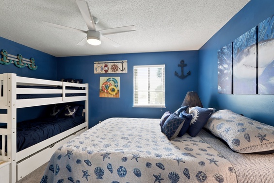 Drift off in this nautical-themed bedroom, where coastal blues and charming décor create a soothing seaside escape. A bunk bed adds extra space for family or friends to join your getaway.