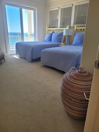 Drift off to the sound of waves in your serene coastal bedroom, where blue linens and stunning sea views invite you to relax completely.