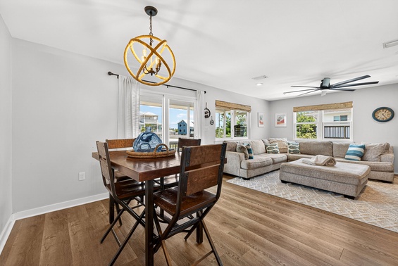 Settle into your bright, open living and dining space where coastal charm meets comfort. The plush sectional is perfect for lounging after beach days.
