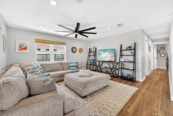 Sink into the plush sectional and unwind in your bright, airy living space—complete with ceiling fan, smart TV, and thoughtful décor that makes relaxing effortless.