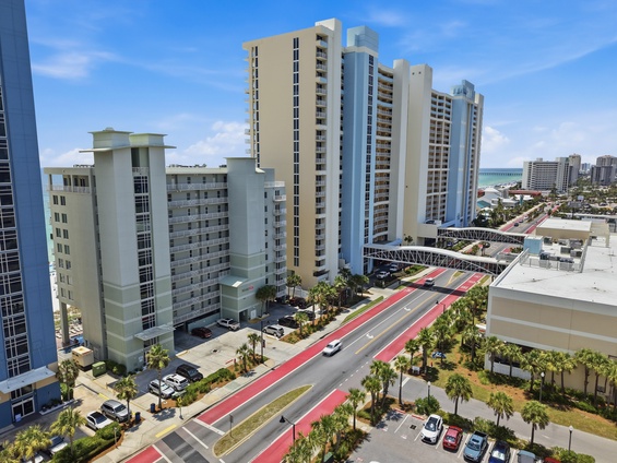 The property sits amid a lively coastal resort district, with high-rise hotels, palm-lined streets, and pedestrian skywalks connecting the area's attractions and beaches.
