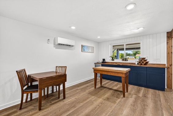 Gather around the charming dining table and enjoy your morning coffee in this bright, open space with warm wood tones and modern conveniences at your fingertips.